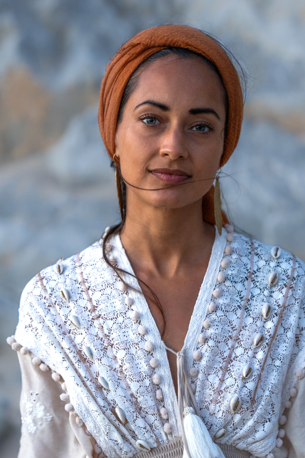 Portrait of a woman in a headscarf and white embroidered top
