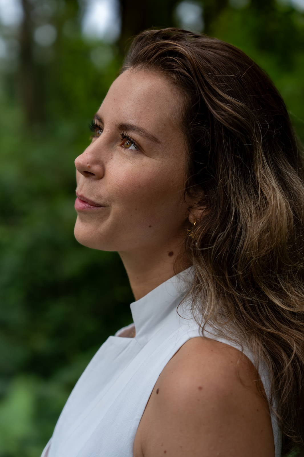 Portrait of a woman looking up, soft green background